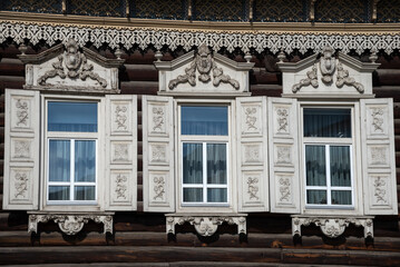 Windows with carved shutters. The Shastin Apartment Building (House of Europe). The historical...