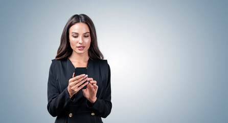 Businesswoman in formal wear using smartphone, realistic photo style, on light gradient background. Concept of communication and digital connection