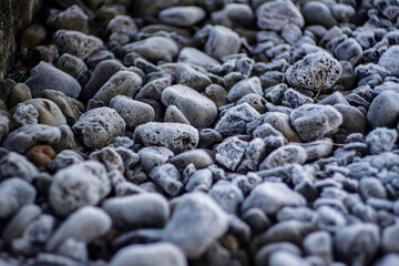 Frost Covered Pebbles and Stones Close-Up Texture