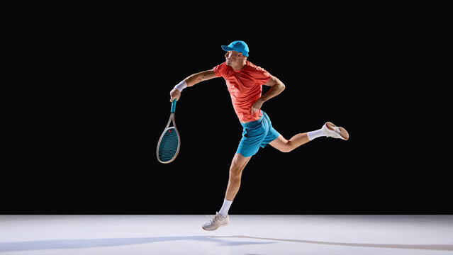Energetic tennis player hitting forehand in jump with confident expression. Concept of creative advertising, visual storytelling, graphic design composition, and energy in movement.