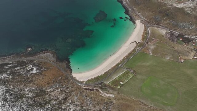 Aerial view of Uttakleivveien's beaches, displaying a stunning contrast between the turquoise waters and the rugged coastline, Leknes, Nordland, Norway.