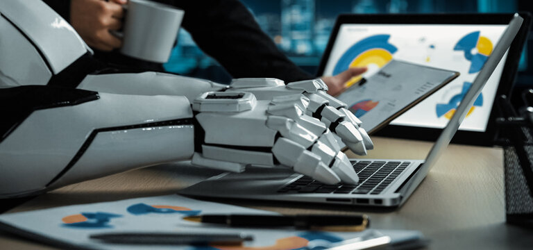 A sleek robotic arm interacts with a laptop, displaying data analysis while a business professional enjoys coffee in the modern office environment.Noogenesis - Powered by Adobe