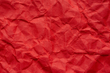 Close-up macro of crumpled red paper,Crumpled paper background made from a blood red sheet of wrapping paper.