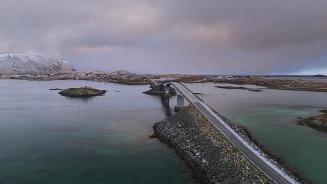 Aerial view of the bridge connecting islands in Fredvang, where the grey bridge contrasts with the turquoise water, Fredvang, Nordland, Norway.