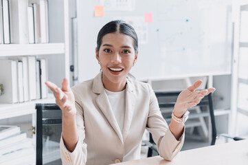 Businesswoman talking to the camera as if in an online meeting or video conference, representing communication, remote work, and modern business connection.