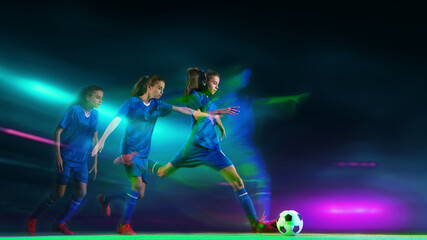Soccer player sequence preparing to kick ball under green and violet neon lights at night stadium. Concept of training concentration, body in motion, performance visuals, and modern sport campaigns.