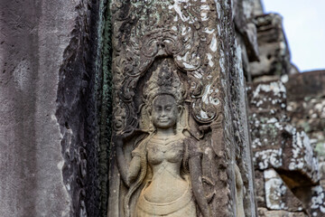 Carved image of apsara on temple wall at Angkor, Cambodia