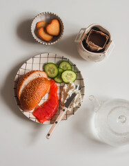 Delicious breakfast, snack - bun, lightly salted salmon, cream cheese, cucumber and coffee drip on...