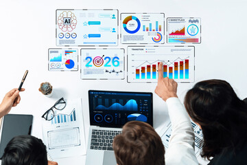 A diverse business team engaged in data analysis, utilizing advanced graphs and charts displayed on various devices, emphasizing collaboration and insight. Trope