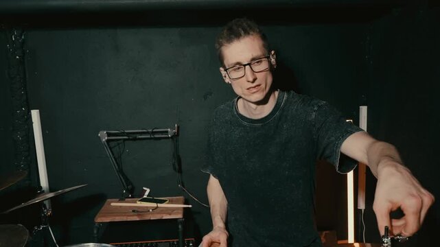 performer actively manipulating sticks and sounds to craft inventive rhythmic patterns and gestures