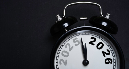 Alarm clock showing the transition from 2025 to 2026 symbolizing new year countdown future planning...