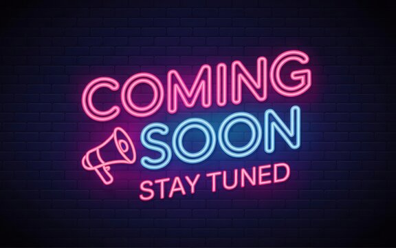 Coming soon" neon sign with megaphone, "stay tuned" text on a brick wall background.