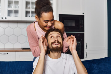 Joyful moments in a cozy home as a young couple enjoys playful time together