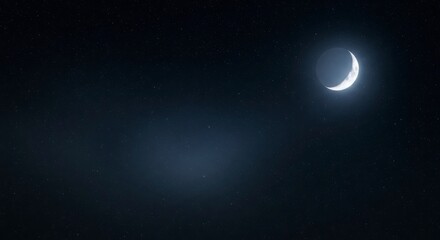 Fototapeta premium Crescent moon illuminating the dark night sky with a distant star and subtle nebula glow