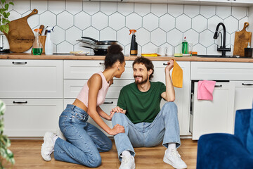 Couple enjoying cozy moments in a bright, modern kitchen during a cheerful afternoon