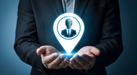 Businessman presents a glowing location pin with a person icon in his hands symbolizing recruitment talent acquisition and human resources in a corporate setting against a dark blue background