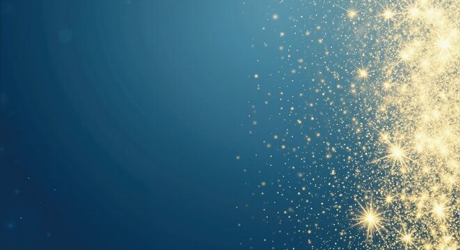 Sparkling gold glitter dust on a dark blue background. Abstract festive texture for holiday celebrations. Copy space for text