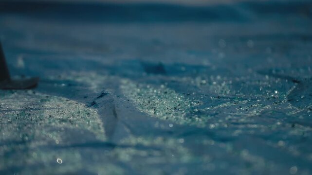 Glass Shards Scattered on Blue Ground with Workshop Light