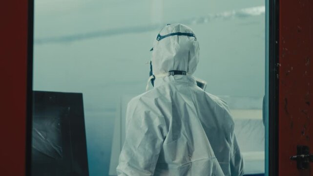 Worker in Protective Suit Preparing Tram Painting Booth