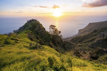 Evening mood, green coastal landscape on a steep cliff at sunset, sea and coast, viewpoint Miradouro da Raposeira, Paul do Mar, Madeira, Portugal