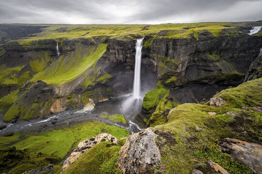 River and waterfalls at a canyon with green moss, Haifoss and Granni waterfall at a canyon, Fossá í Þjórsárdal, with river í Þjórsárdal, long exposure, dramatic landscape, Hekla, Iceland
