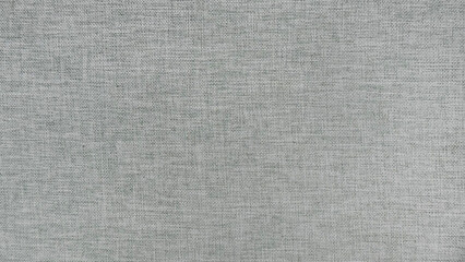 Light grey linen fabric texture background. High resolution close up of natural woven textile surface. Silver gray canvas material pattern for abstract wallpaper or furniture upholstery design.