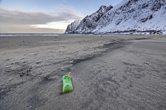 Empty plastic bottle on the beach, plastic waste, Senja, Troms, Norway