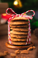 Handmade cookies wrapped with festive rope, capturing the spirit of Christmas and New Year  perfect as heartfelt gift in cozy vertical holiday photo concept.