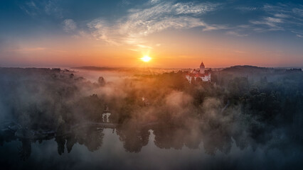 view of Konopiste Castle at sunrise in the fog