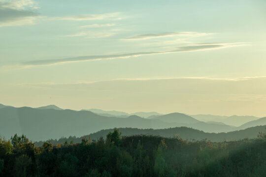 Tirana's dense, modernizing cityscape and colorful buildings set against the majestic Dajti mountains under varied light