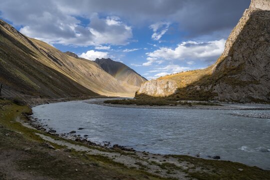 Mountain valley with Sary Jaz river and rainbow, autumn mountains with yellow grass, Tien Shan, Kyrgyzstan