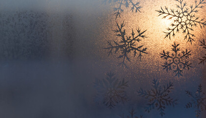 Elegant winter snowflakes glistening with sunlight on frosted glass texture art