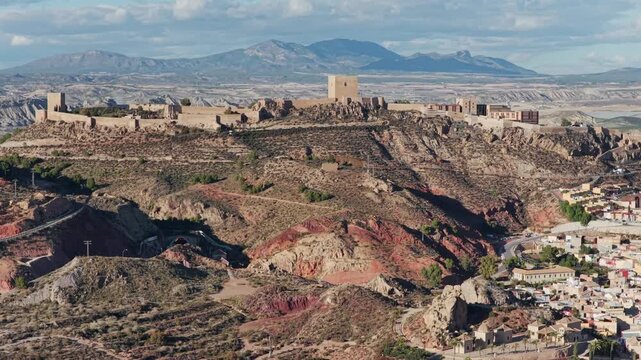 Majestic Lorca Castle Fortress and Historic City: Aerial View Overlooking the Arid Landscape of Murcia, Southern Spain