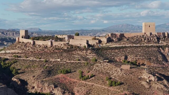 Majestic Lorca Castle Fortress and Historic City: Aerial View Overlooking the Arid Landscape of Murcia, Southern Spain