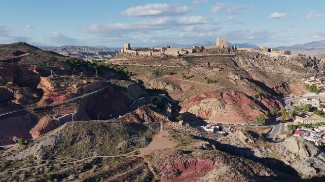 Majestic Lorca Castle Fortress and Historic City: Aerial View Overlooking the Arid Landscape of Murcia, Southern Spain