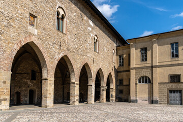 Bergamo's historic architecture under a bright blue sky