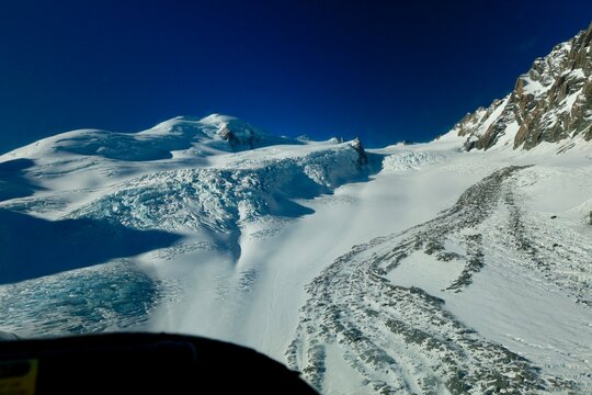 Mt Cook Glacier, NZ - May 24, 2025 (In-Flight): A dynamic view from the cockpit showing the ski of the fixed-wing aircraft just above the snow as it performs a glacier landing on the Tasman Glacier