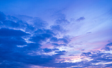 Purple clouds and sky,A beautiful sunset sunrise blue sky with a few clouds and a pinkish tint. The sky is calm and peaceful and the clouds add a sense of depth and texture to the scene.