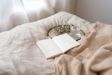 Notebook and water on a calm morning bed