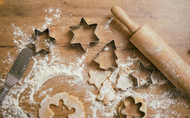 Top-down view of holiday cookie making supplies and dough.