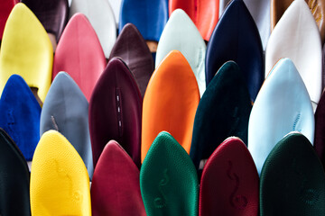 Colorful collection of high-heeled shoes displayed in a retail setting, showcasing various textures and materials, emphasizing fashion trends and stylish footwear options for modern consumers