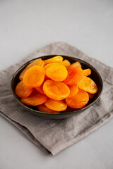 Organic Raw Dry Apricots in a Bowl, side view.