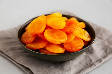 Organic Raw Dry Apricots in a Bowl, side view. Close-up.