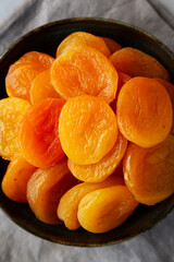 Organic Raw Dry Apricots in a Bowl, top view. Close-up.
