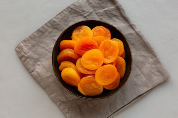 Organic Raw Dry Apricots in a Bowl, top view. Overhead, from above.