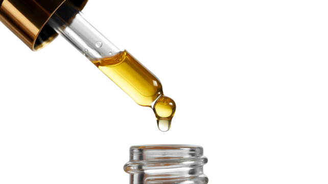 Golden oil dripping from glass dropper into bottle isolated on transparent background