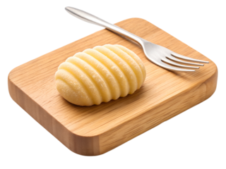 Butter curl on wooden board isolated on transparent background with fork nearby