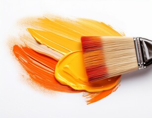 paintbrush with vibrant orange and yellow paint strokes isolated on white background