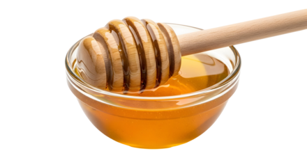 Wooden honey dipper scooping golden honey from a glass jar