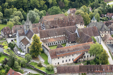 Aerial view of Bebenhausen Abbey's monastic architecture, its red-tiled roofs contrasting with the lush greenery surrounding the historic site, Bebenhausen, Baden-Wurttemberg, Germany.